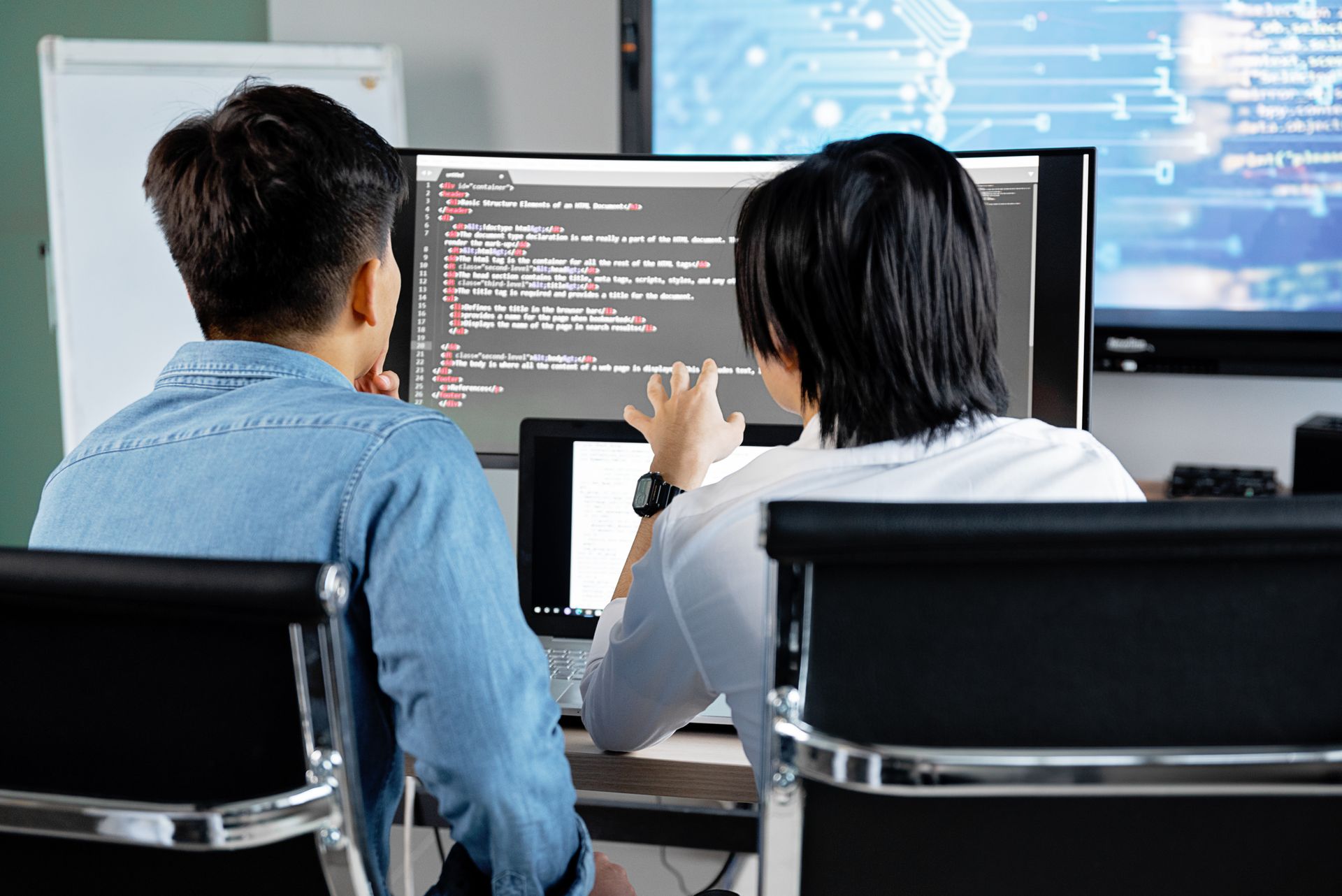 Two colleagues discussing code at work